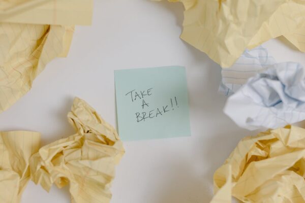 A top view of crumpled papers surrounding a sticky note with 'Take a Break'.