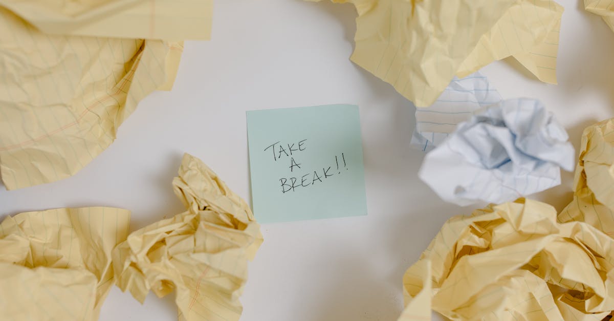 A top view of crumpled papers surrounding a sticky note with 'Take a Break'.